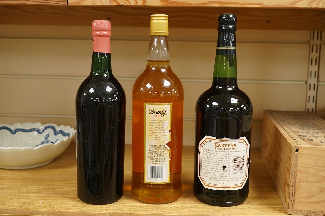 A bottle of Fonseca 1970 vintage port, a bottle of 1970 Chateau Grand-Puy-Lacoste, a litre bottle of Bounty rum and a litre bottle of Harvey’s Bristol Cream